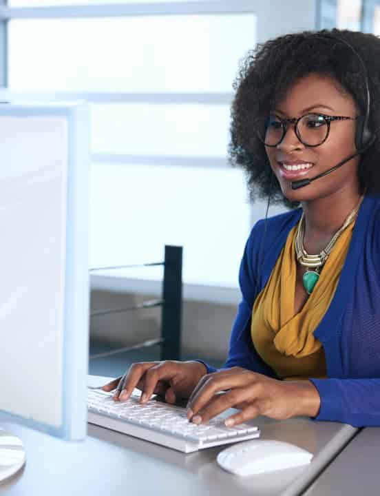 woman with headset working on computer