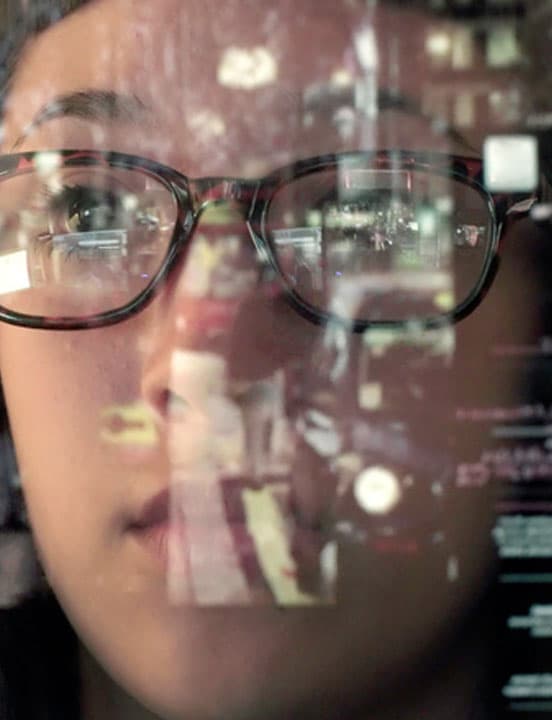 reflection of computer screen in woman's glasses