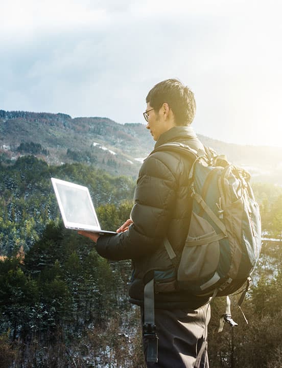man backpacking with laptop computer