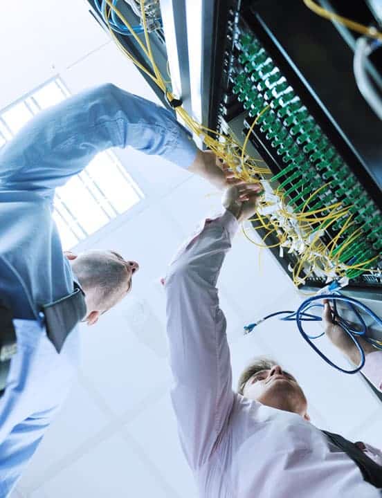 two men performing a network assessment in data center