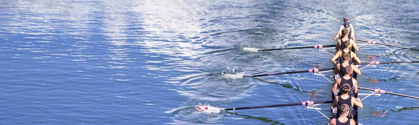 rowing team using power to paddle boat