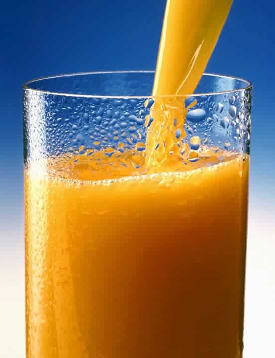 pouring sunny delight into a glass