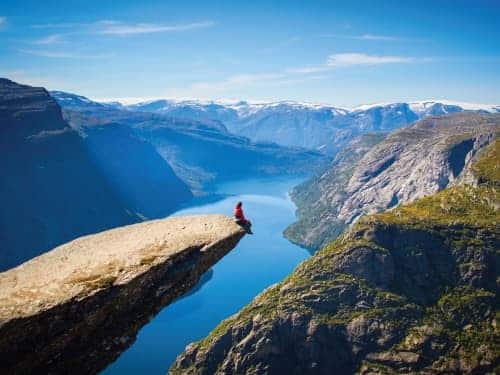 man on the edge of a rock with nothing below
