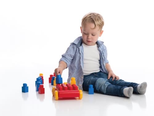 Child playing with diplo building blocks