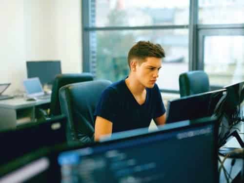 young man working at a computer in office