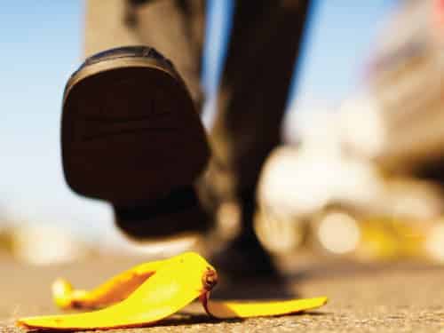 person stepping on banana peel