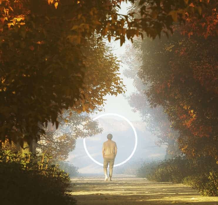 Young man walking towards mysterious portal