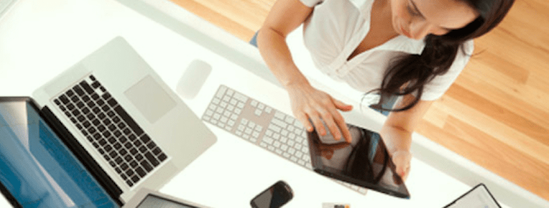 woman working on multiple devices