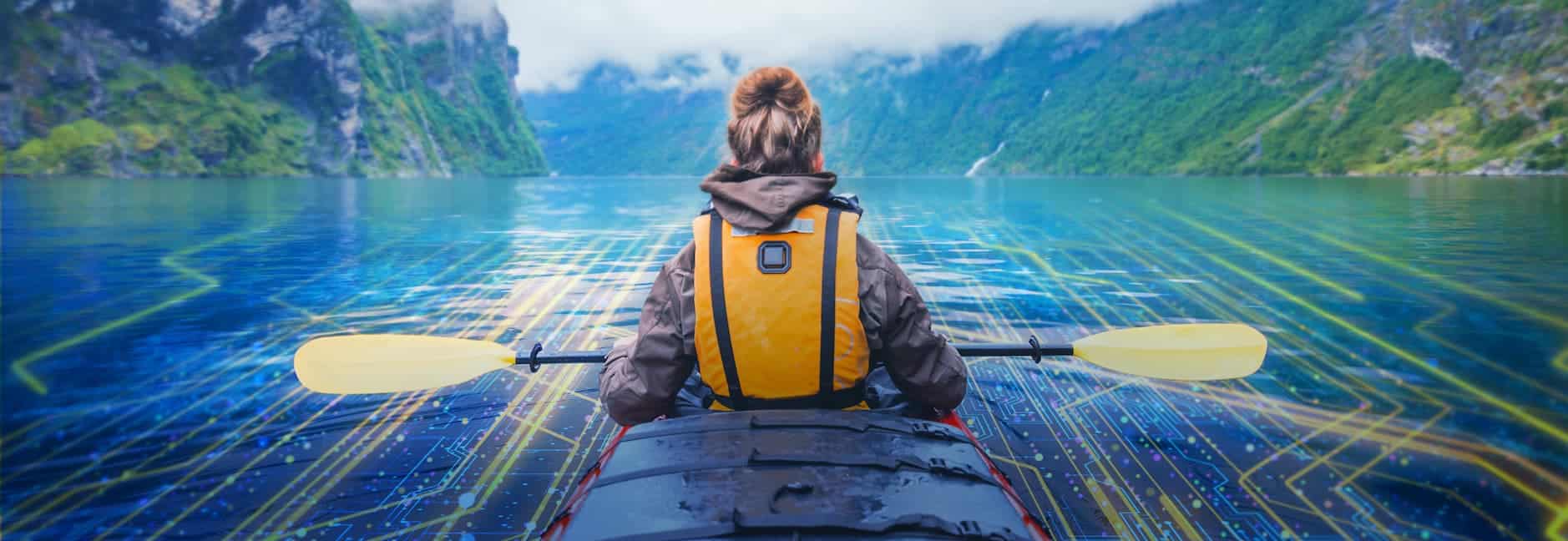 woman kayaking in mountain lake