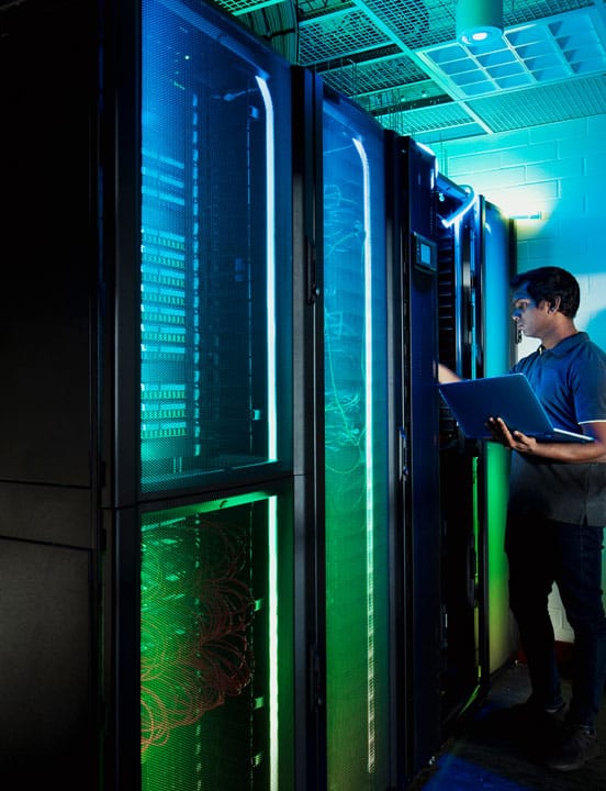 man checking servers in data center