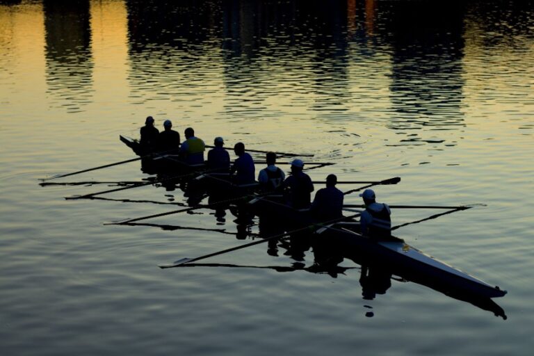 A team rowing together with coordination and good communication.