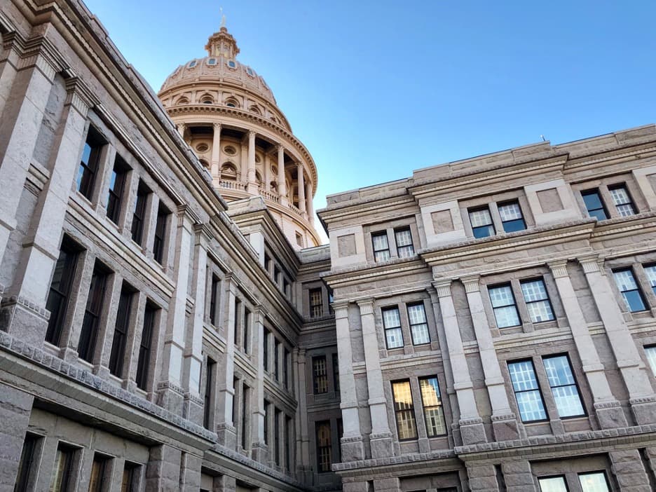 The Texas State Capitol set against a clear blue sky.