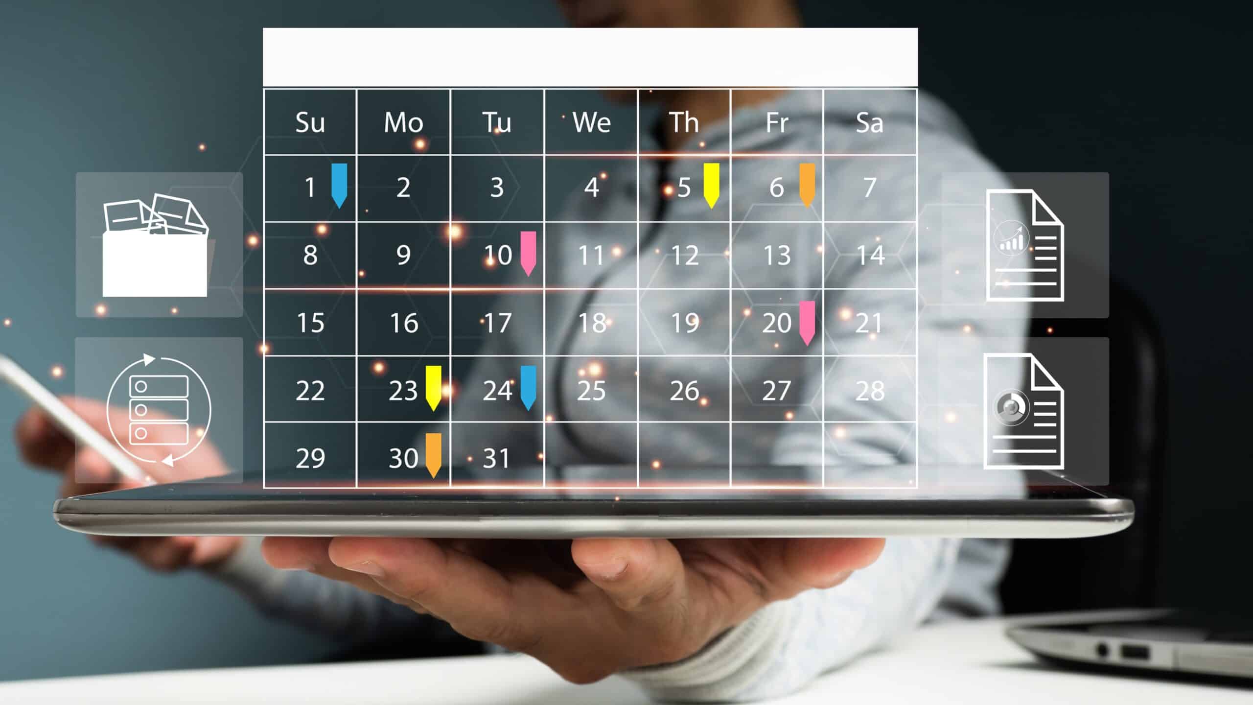 On office table, a man is using his mobile phone and making appointment on the calendar desk using Microsoft Bookings.