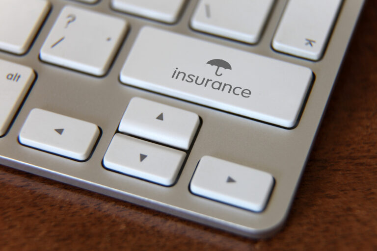 Keyboard with symbol for cybersecurity insurance.