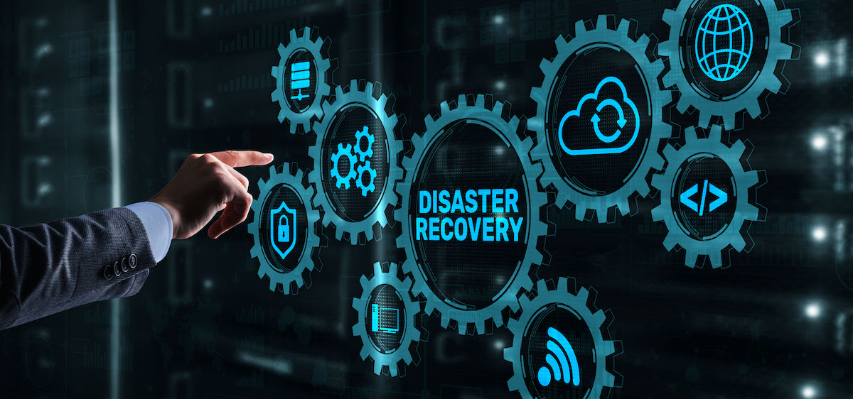 Businessman pressing recovery on virtual screen for Disaster Recovery in Xi Leap blog.